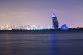 Dubai night landscape showing luxury skyline of modern hotels and skyscrapers. Illuminated Burj al Arab and Burj Khalifa. Royalty Free Stock Photo