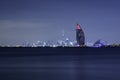 Dubai night panorama showing luxury skyline of modern hotels and skyscrapers. Illuminated Burj al Arab and Burj Khalifa. Shot at f Royalty Free Stock Photo