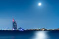 Dubai night panorama showing luxury skyline of modern hotels and skyscrapers. Illuminated Burj al Arab and Burj Khalifa.