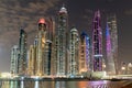 Dubai skyline at night with lights on the water and luxirious skyscrapers of UAE. Royalty Free Stock Photo