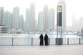 Dubai - skyline at sunrise of Dubai business center, two women in United Arab Emirates Royalty Free Stock Photo
