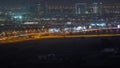 Dubai skyline with villa houses and construction site of new towers on a background aerial night timelapse. Royalty Free Stock Photo