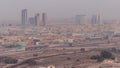 Dubai skyline with villa houses and construction site of new towers on a background aerial timelapse.