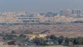 Dubai skyline with villa houses and construction site of new towers on a background aerial timelapse.