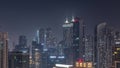 Dubai skyscrapers with illumination in business bay district during all night timelapse. Royalty Free Stock Photo