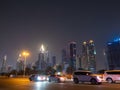 Dubai skyscrapers at night with road traffic late at night. Royalty Free Stock Photo