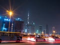 Dubai skyscrapers at night with road traffic late at night. Royalty Free Stock Photo