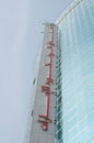 dubai tall glass building with arabic typography, dubai, uae