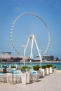 Dubai, UAE, 22.02.2021. Ain Dubai Dubai Eye tallest ferris wheel in the world on Bluewaters Island with JBR beach restaurant Royalty Free Stock Photo