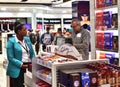 Dubai, UAE - April 10. 2018. The buyer at checkout in duty free shop at the airport Royalty Free Stock Photo