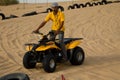 DUBAI, UAE - APRIL 20, 2012: Safari camp staff riding an ATV All Terrain Vehicle