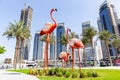 Big flamingos statues on Dubai Creek Harbour promenade with skyline in the background