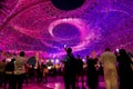 Dubai, UAE - December 4, 2021: Al Wasl Plaza glowing with purple colors at Expo 2020 and visitors watching. Pantone