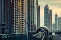 DUBAI, UAE - DECEMBER 16, 2015: Dubai modern architecture at sunset with a metro station.