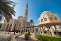 DUBAI, UAE - DECEMBER 2016: Exterior view of Jumeirah Mosque along the sea with city skyline on background Royalty Free Stock Photo