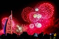 Explosion of multi-colored fireworks at Burj Al Arab Jumeirah Dubai against the night sky on a new year c