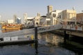 Al Seef Village at Bur Dubai. Al Seef old style area with people. Wooden piers with big dhow boat.