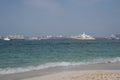 Dubai, UAE - February 2021: Distant sea view of Palm Jumeirah hotels and luxury yachts