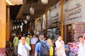 Dubai\'s Old Souk market bustling with tourists. The market is a maze of narrow, crowded alleys