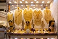 Golden jewelry - massive golden necklaces, armors, rings and hats displayed in a gold store in Dubai Gold Souk, Deira Royalty Free Stock Photo