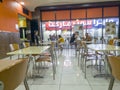 Dubai, UAE - 10.02.2022 - Group of asian expats having a meal in fast food outlet. Lifestyle Royalty Free Stock Photo