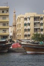 DUBAI, UAE - JANUARY 18, 2017 : Dubai Creek. Small ships and dhows line the Deira side of the creek while abras cross from Bur Du