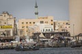 DUBAI, UAE - JANUARY 18, 2017 : Dubai Creek. Small ships and dhows line the Deira side of the creek while abras cross from Bur Du