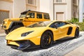 DUBAI, UAE - JANUARY 08, 2019: yellow luxury supercar Lamborghini Aventador Roadster and Gelandewagen in Dubai