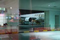 Emirates Airlines jetliner parking on apron viewed from waiting lounge of arrival gate inside at Dubai International Airport