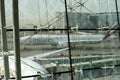 View of Emirates Airlines airplane parking on apron viewed from waiting lounge inside the terminal at Dubai Intenational Airport Royalty Free Stock Photo