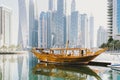 Dubai; UAE - June 6, 2020: Traditional Arabic Dhow boat standing at pier at Dubai Marina