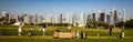 Golfers practice on driving range with Dubai skyline in the back