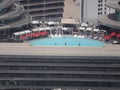 Big oval swimming pool with clean blue water on the luxurious cruise ship with tourists on vacation.