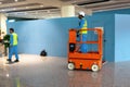 DUBAI, UAE - MARCH 24: Orange hydraulic scissor platform stand by for service and maintenance in work area