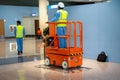 DUBAI, UAE - MARCH 24: Orange hydraulic scissor platform stand by for service and maintenance in work area