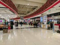 Dubai, UAE - March 02, 2022: In the terminal of Dubai Airport, people with luggage go shopping and look at souvenirs