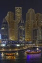 DUBAI, UAE - March 8th 2019: Dubai Marina skyscrapers, port with luxury yachts and Marina promenade at night, Dubai