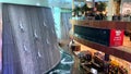 Human Waterfall. Divers waterfall in Dubai mall, view fron the upper floor. Silver men sculptures.