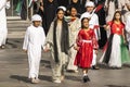 children in traditional clothes wave flags of the United Arab Emirates