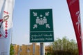 Dubai UAE - November 2019: Emergency assembly point information sign in white paint on green background fixed to a pole to direct