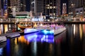 The night illumination of Dubai Marina and catamaran and traditional Dhow boat Royalty Free Stock Photo