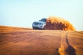 Off-road adventure with Nissan Patrol SUV in Arabian Desert at sunset. Offroad vehicle bashing through sand dunes Royalty Free Stock Photo