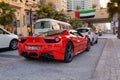Dubai, UAE - November 20, 2013. Red Ferrari driving in Dubai Maria district