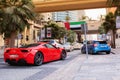 Dubai, UAE - November 20, 2013. A red Ferrari driving in Dubai Maria district