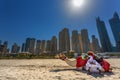 DUBAI, UAE - OCTOBER 11: Bedouin with camels on the beach at Jumeirah Beach Residence in Dubai. October 11, 2014 in Dubai, United