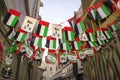 Many UAE flags on old Dubai city background. Royalty Free Stock Photo