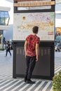 Dubai, UAE - 11.18.2021 - Opportunity district of EXPO 2020. Teenage boy studying map of the venue. Event Royalty Free Stock Photo