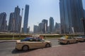 two taxi cars waiting for passengers in the street. Dubai city