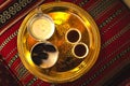 Dubai, UAE - 12th october, 2022: Top view coffee set up on silver plate of two cups and dates in bowl in coffee museum in Dubai