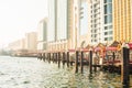 Dubai, UAE - 12th october, 2022: vintage boats and ships on river by beautiful new buildings in Dubai creek district in summer Royalty Free Stock Photo